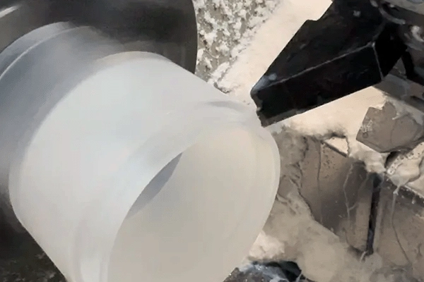 Turning a translucent plastic cylinder, workshop photograph from the company website.
